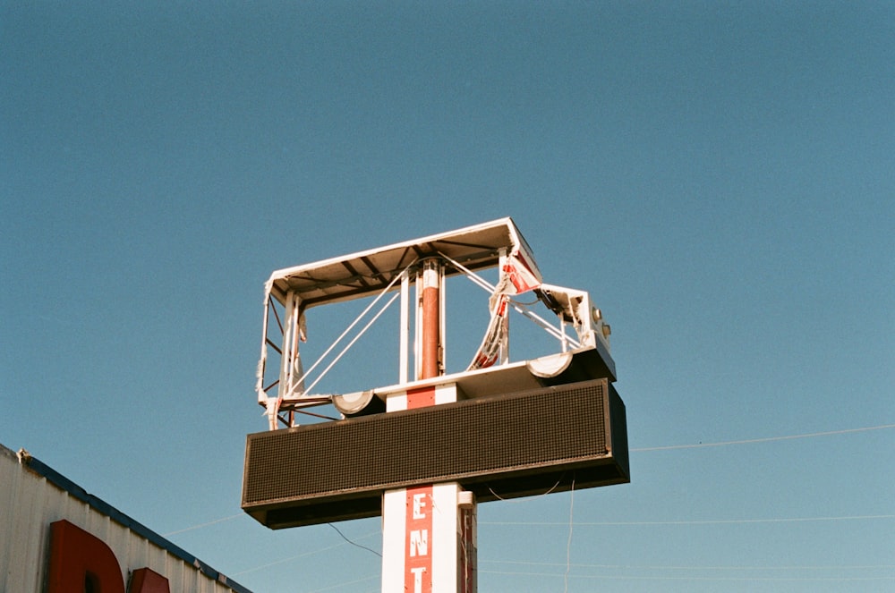 a sign for a business with a sky background