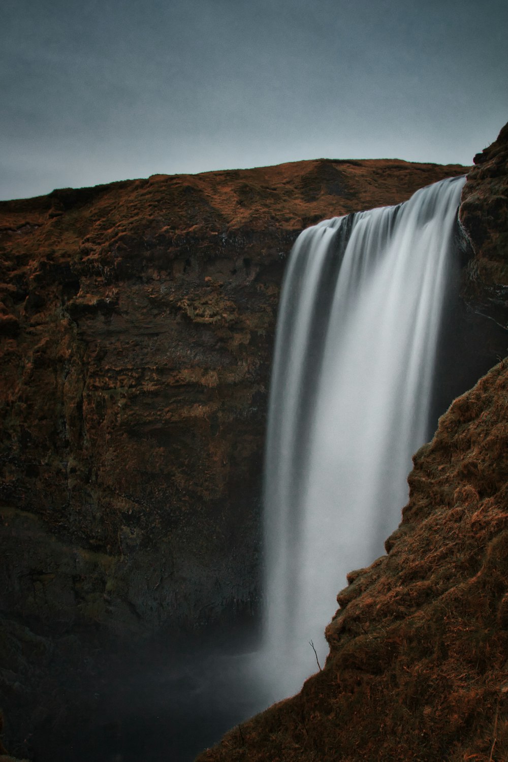 a very tall waterfall with a bunch of water coming out of it