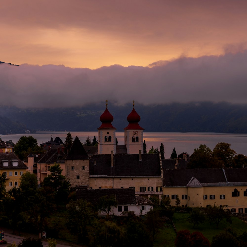 a view of a town with a lake and mountains in the background