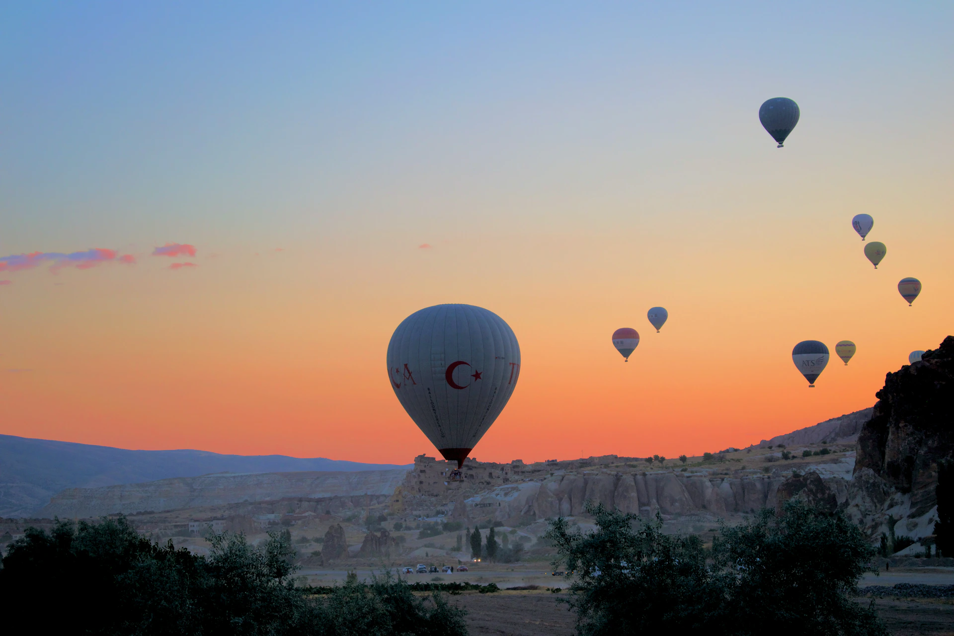 a group of hot air balloons flying in the sky
