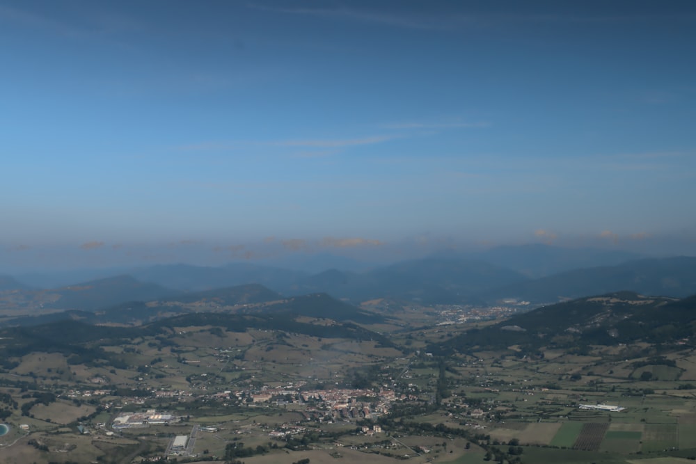 an aerial view of a town and mountains