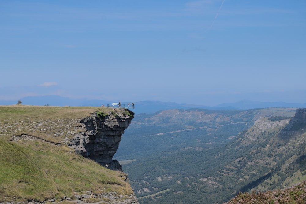 a person standing on top of a cliff