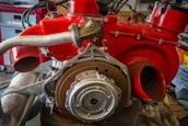 An influencer filming a detailed engine tuning session inside a modern performance workshop.