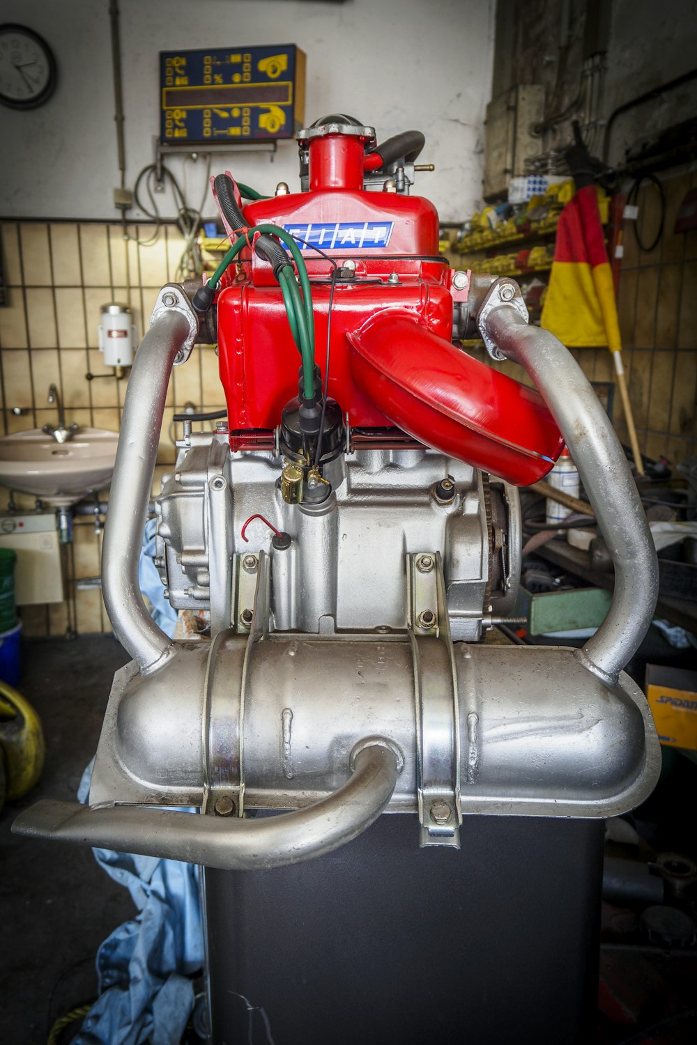 a close up of a red engine in a garage