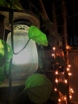 A glowing lantern illuminating a cozy workspace filled with music equipment.