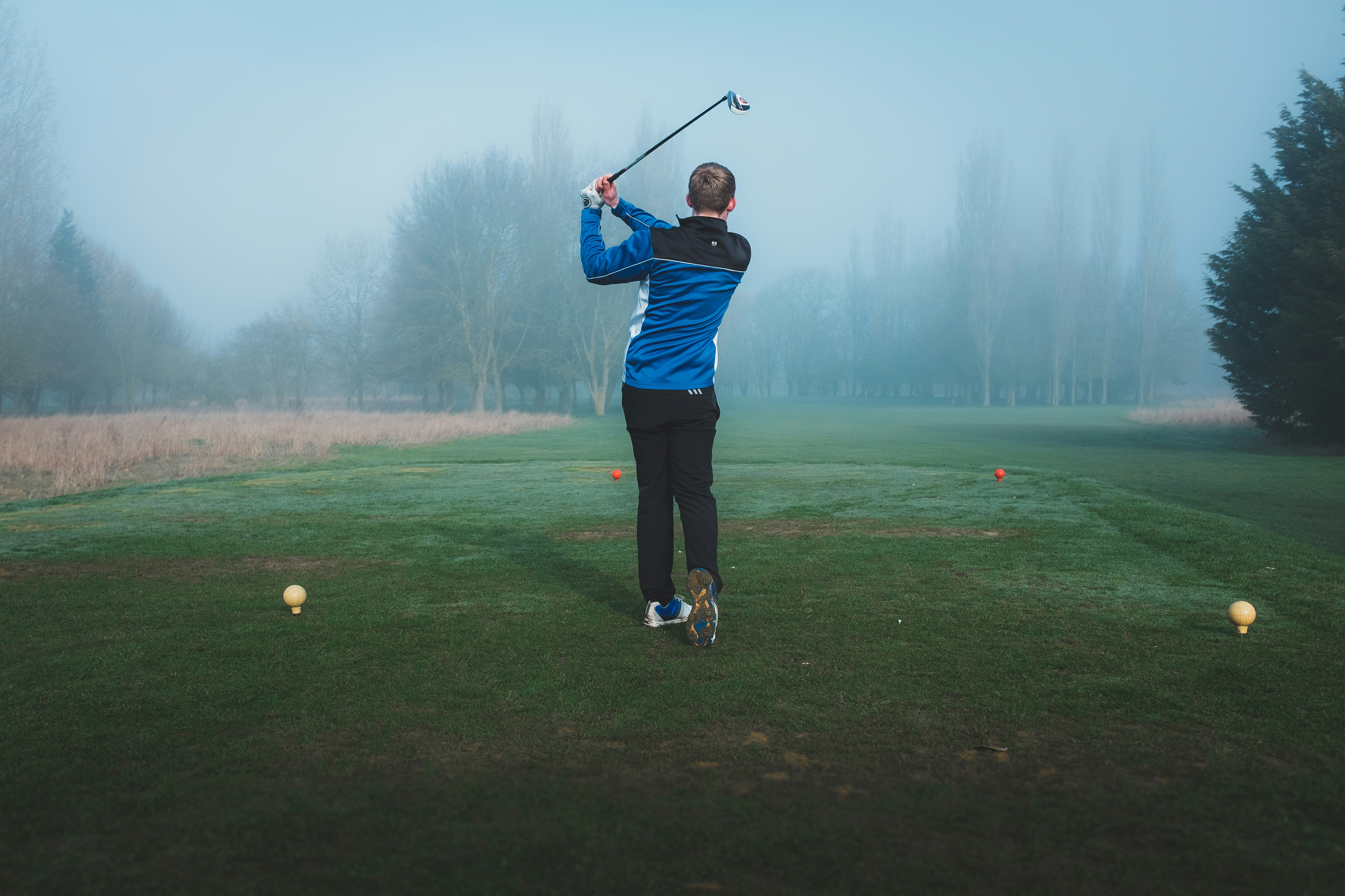 a man flying through the air on a golf course