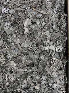 An artistic arrangement of finger-sized polymer clay charms with tiny watch parts embedded.