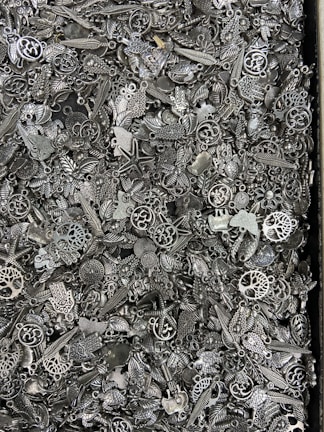 A selection of intricate charms arranged on a wooden table.