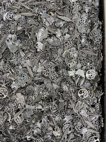 An artistic arrangement of finger-sized polymer clay charms with tiny watch parts embedded.