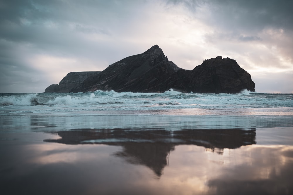 a body of water with a mountain in the background