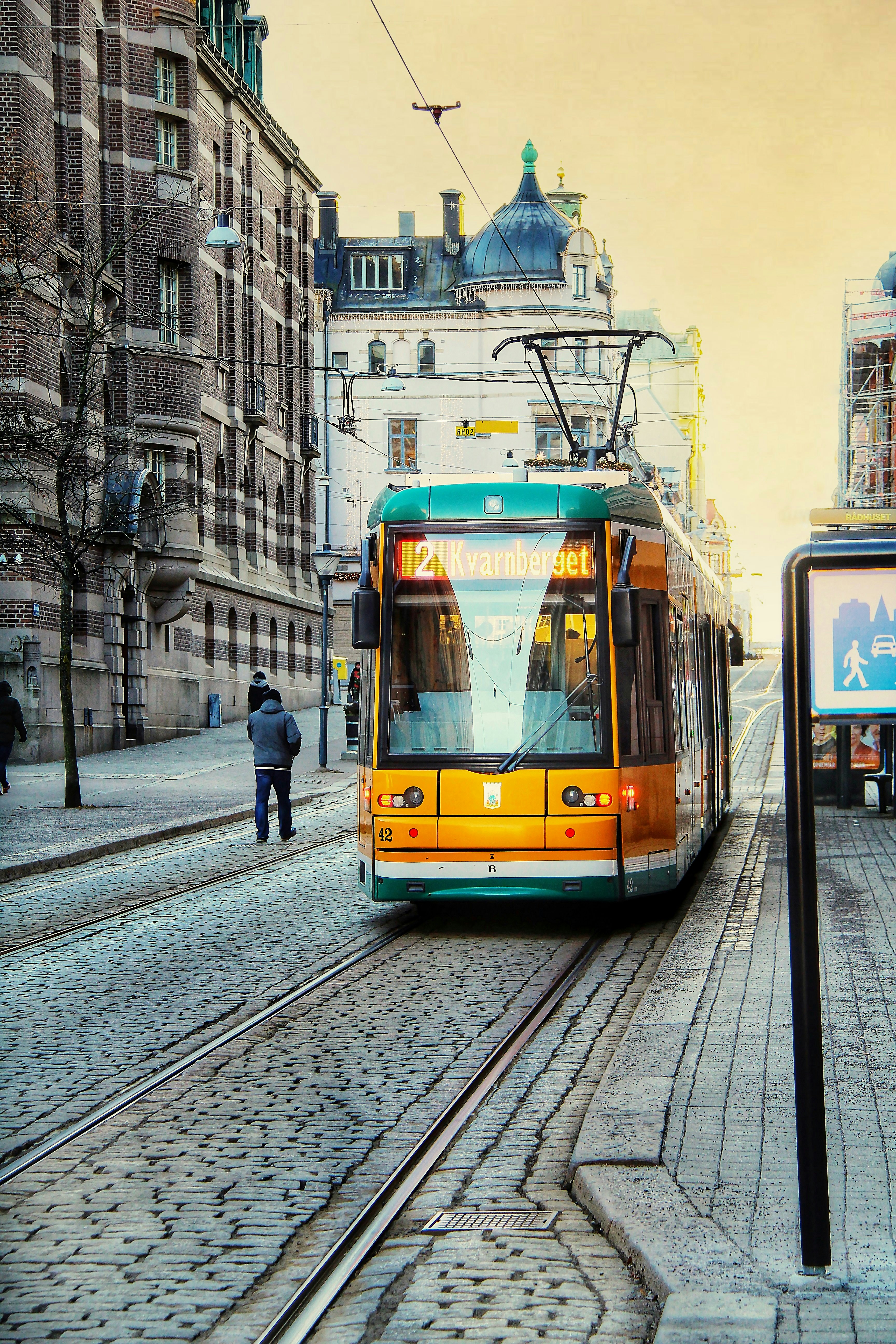 a trolley is coming down the tracks in a city