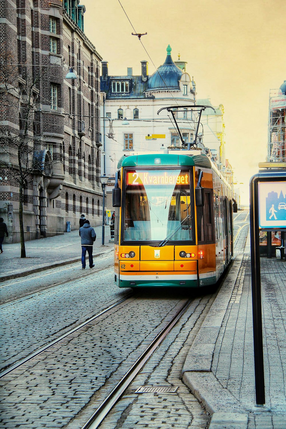 a trolley is coming down the tracks in a city