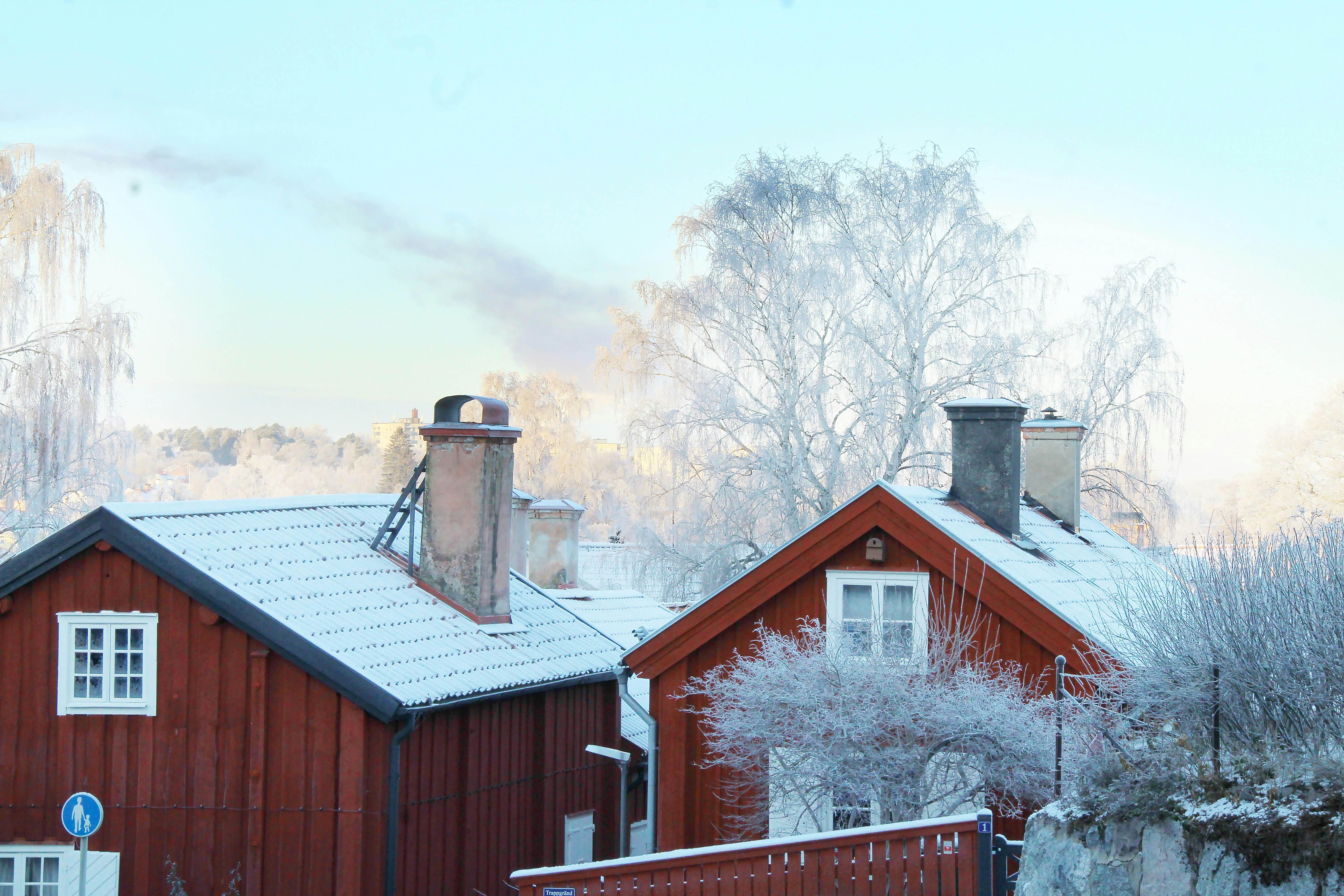 a red house with snow on the roof