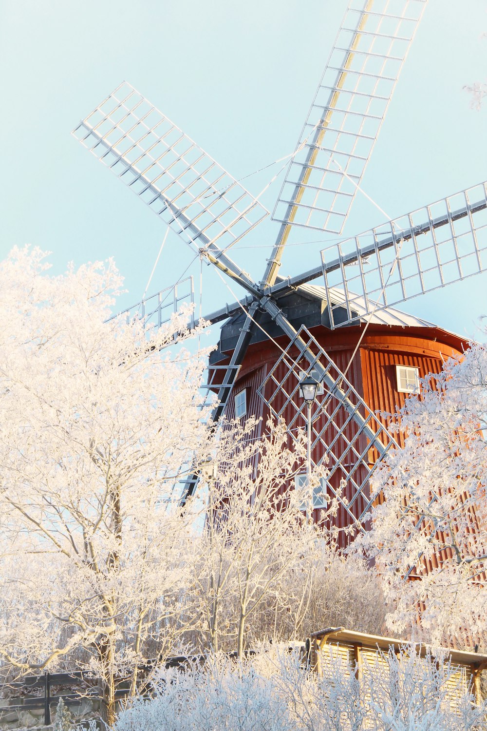 a windmill in the middle of a snowy field