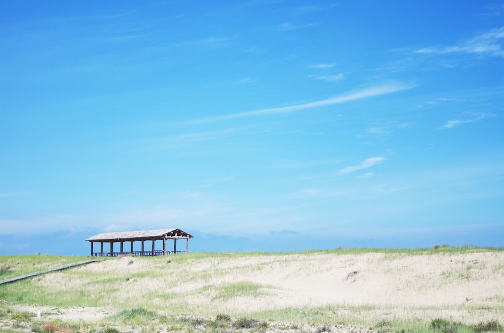 a gazebo in the middle of a grassy field