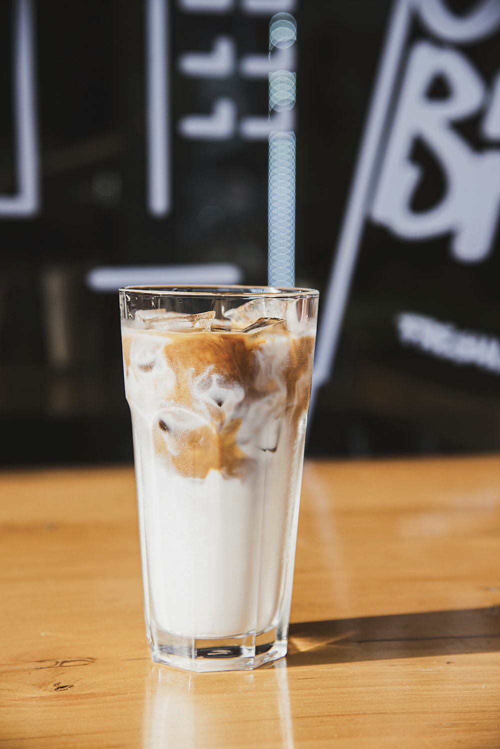 a glass of ice cream with a straw sticking out of it