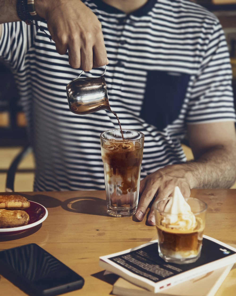 a man pours a beverage into a glass