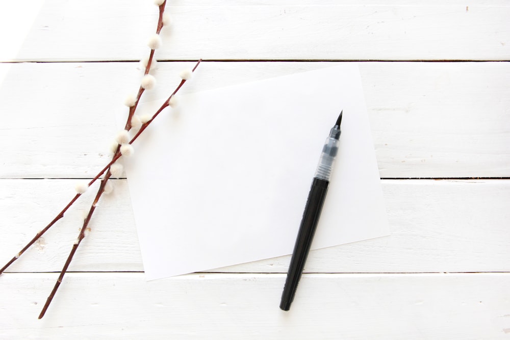 a pen sitting on top of a piece of paper