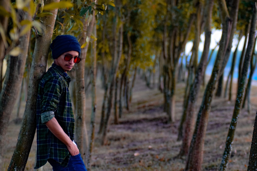 a man standing in the middle of a forest