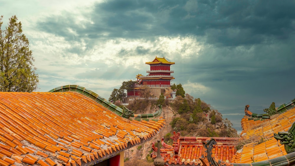 a red and yellow building on top of a hill