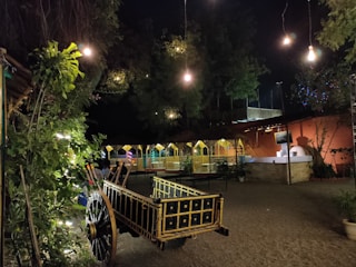 Outdoor party setup with rustic decorations and string lights.