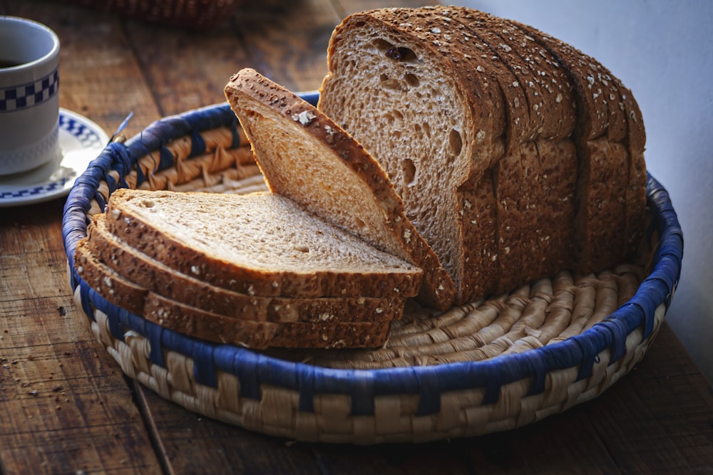 a loaf of bread sitting on top of a blue and white basket