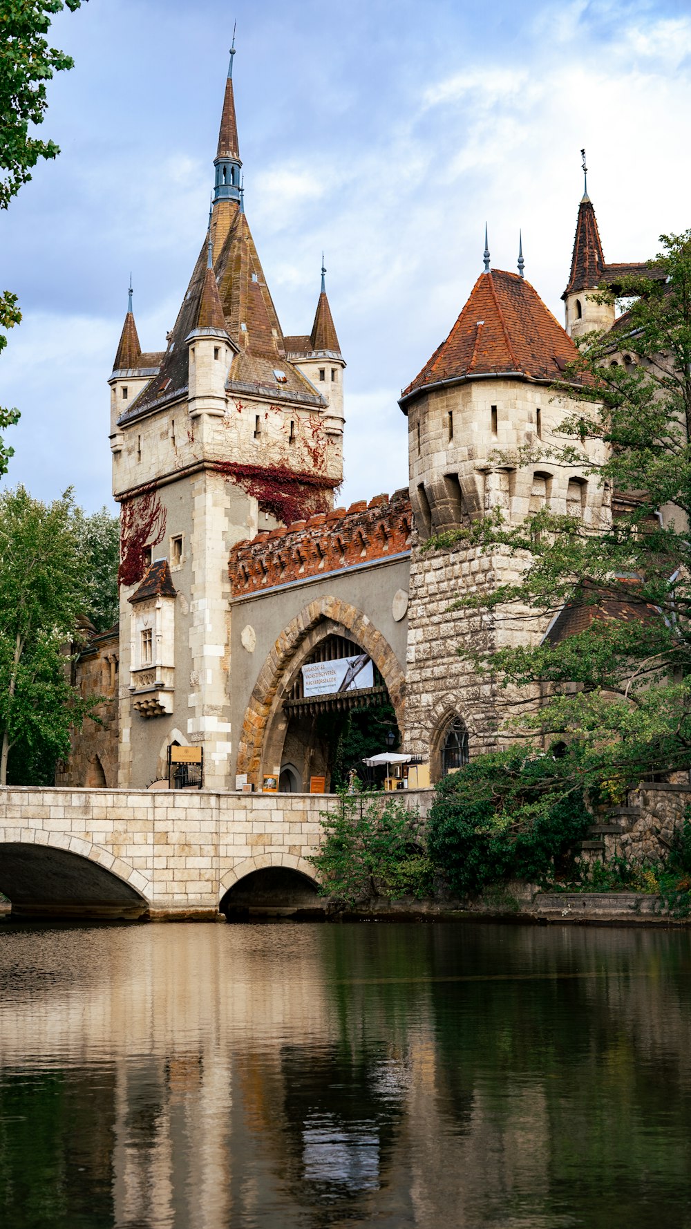 un château avec un pont sur un plan d’eau