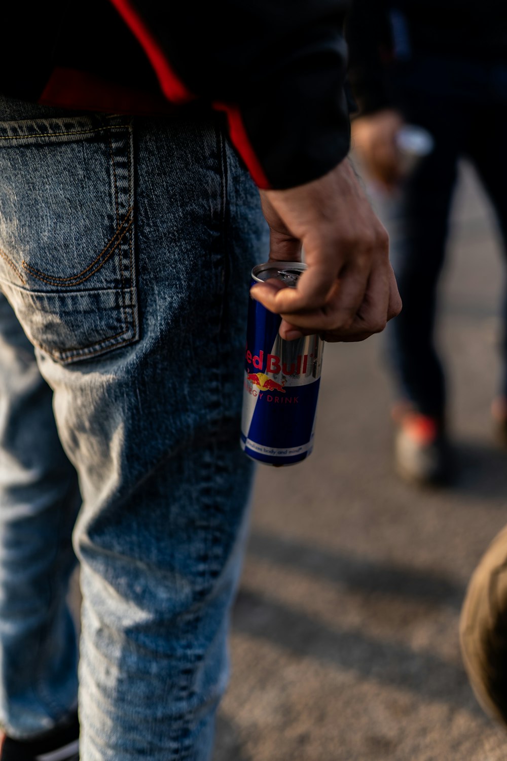 a close up of a person holding a can of beer