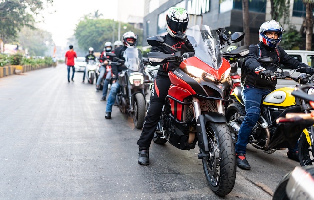 a group of people riding on the back of a motorcycle