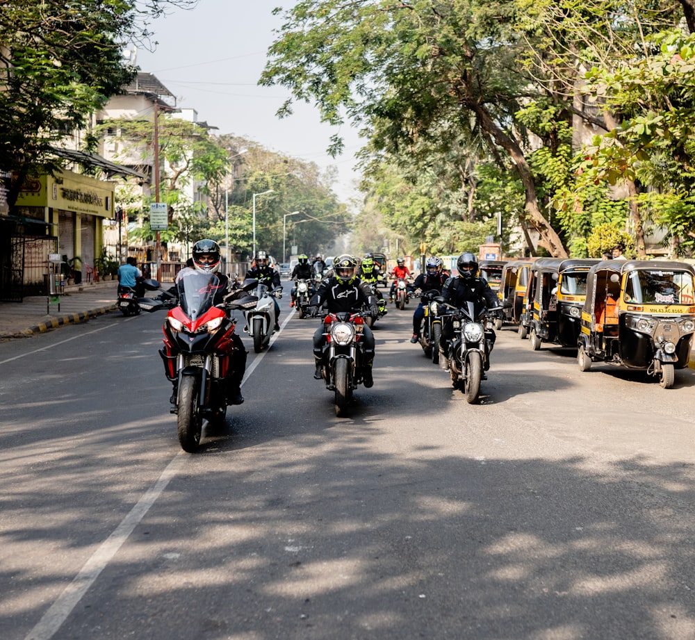 a group of people riding a motorcycle down a street