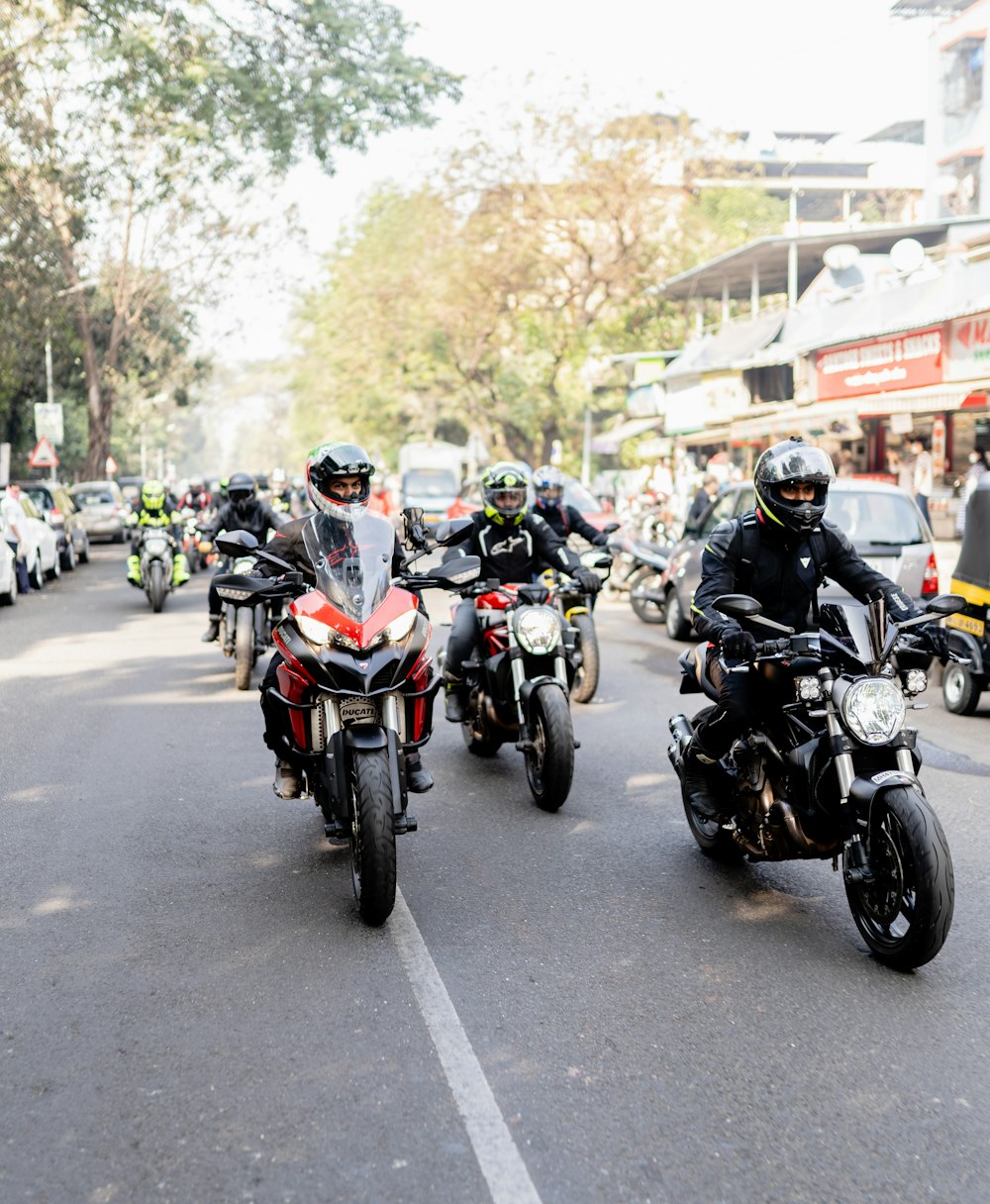 a group of people riding a motorcycle down a street