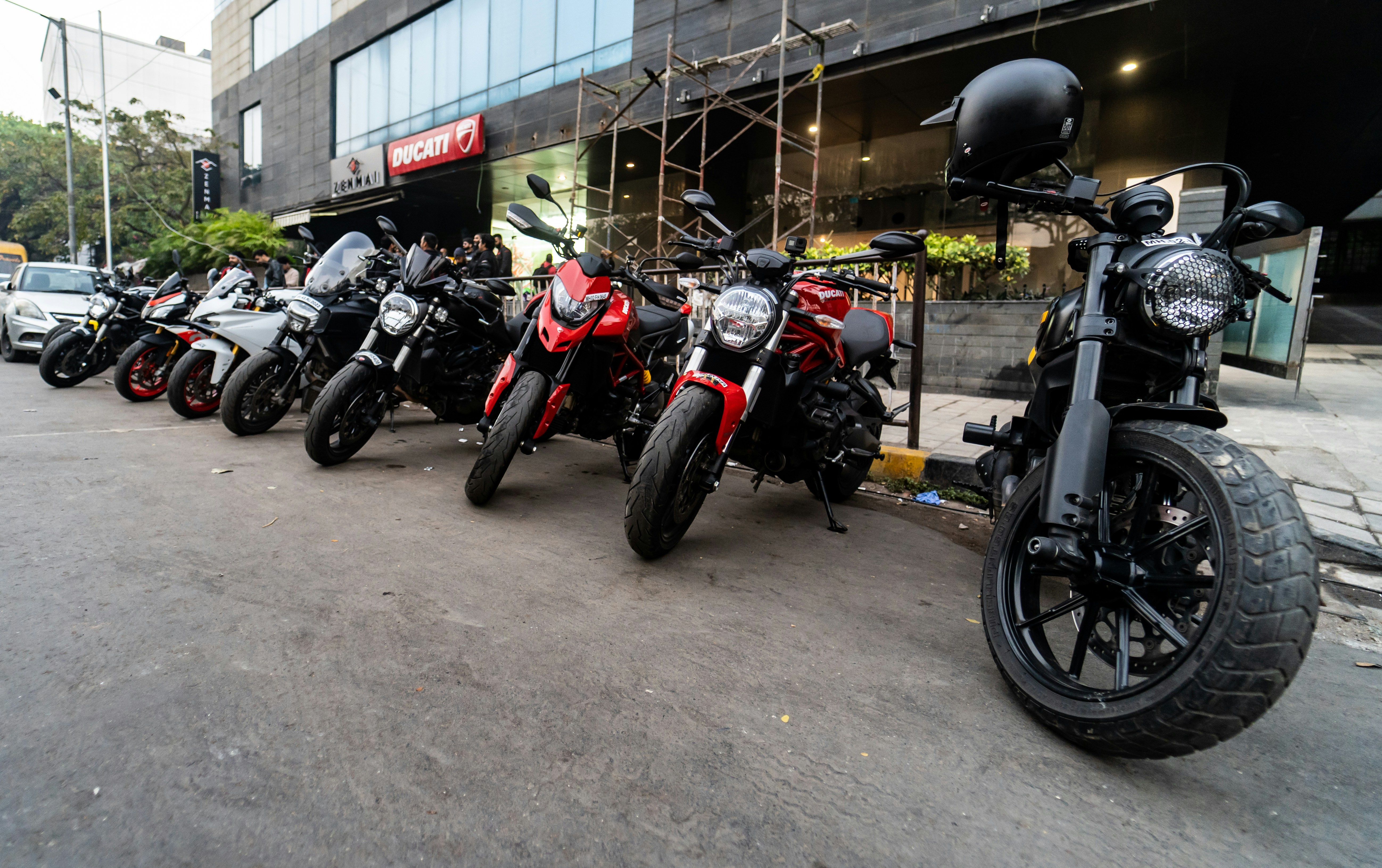 a row of parked motorcycles sitting on the side of a road