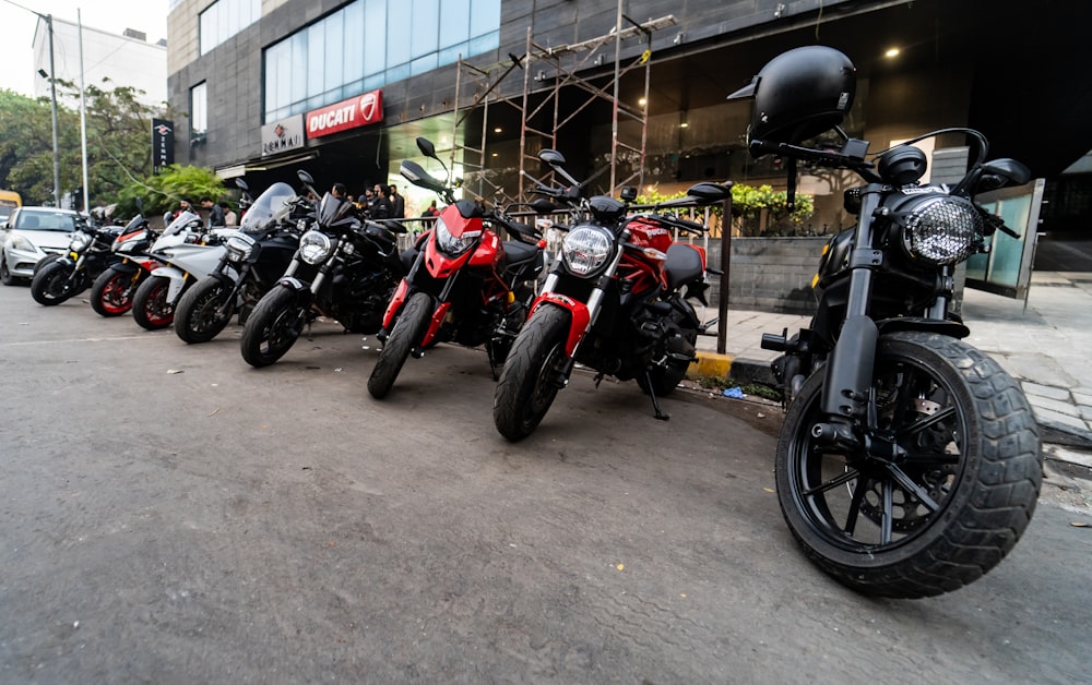 a row of parked motorcycles sitting on the side of a road