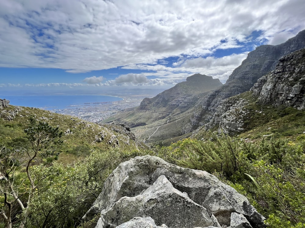 a view of a mountain range from the top of a hill