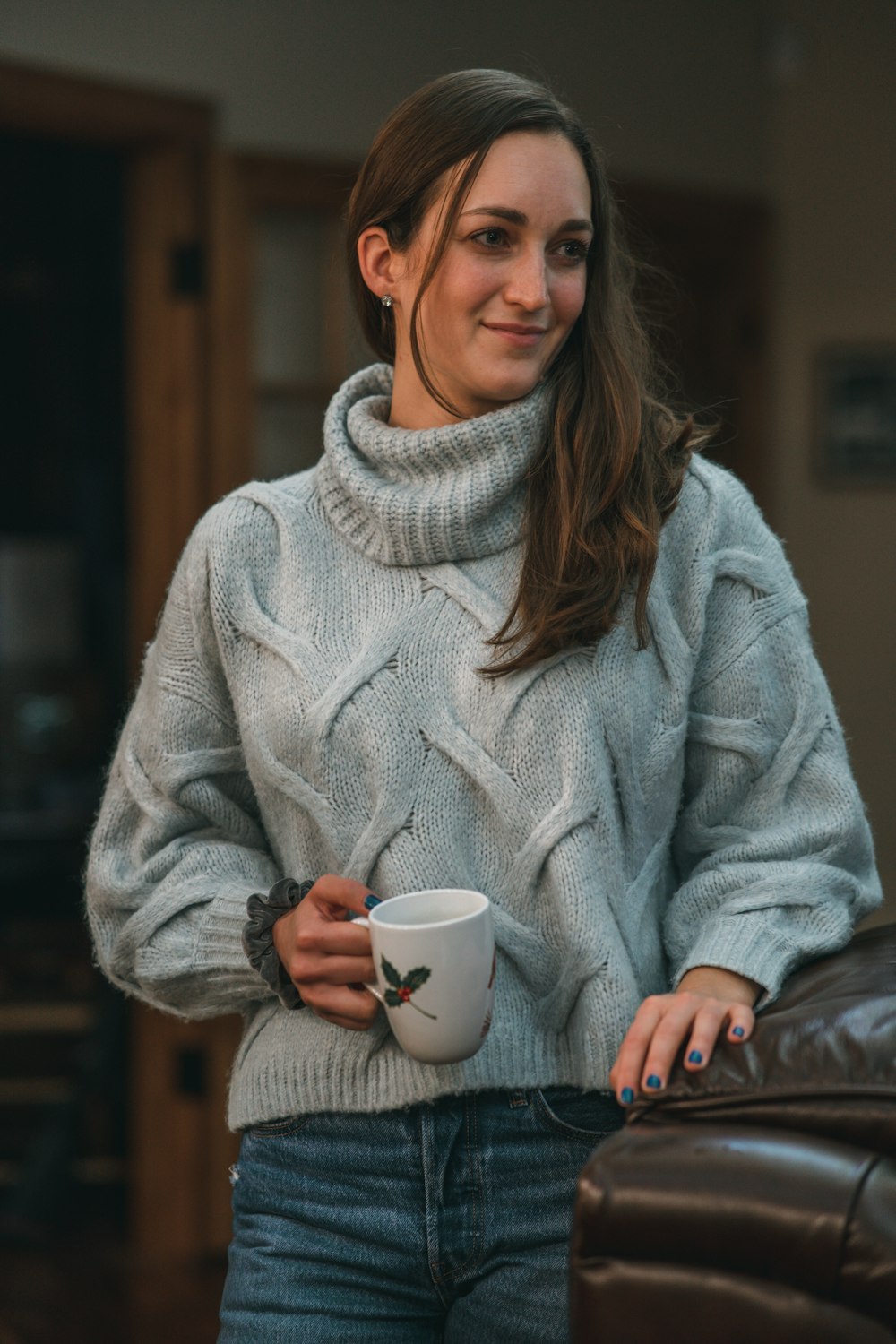 a woman holding a cup of coffee