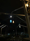 Aesthetic outdoor seating area with black and gold decor under soft lighting.