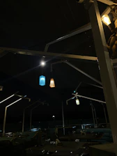 Aesthetic outdoor seating area with black and gold decor under soft lighting.