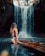 A person in swimwear stands on a bamboo raft in a river, facing a tall, cascading waterfall surrounded by lush vegetation.