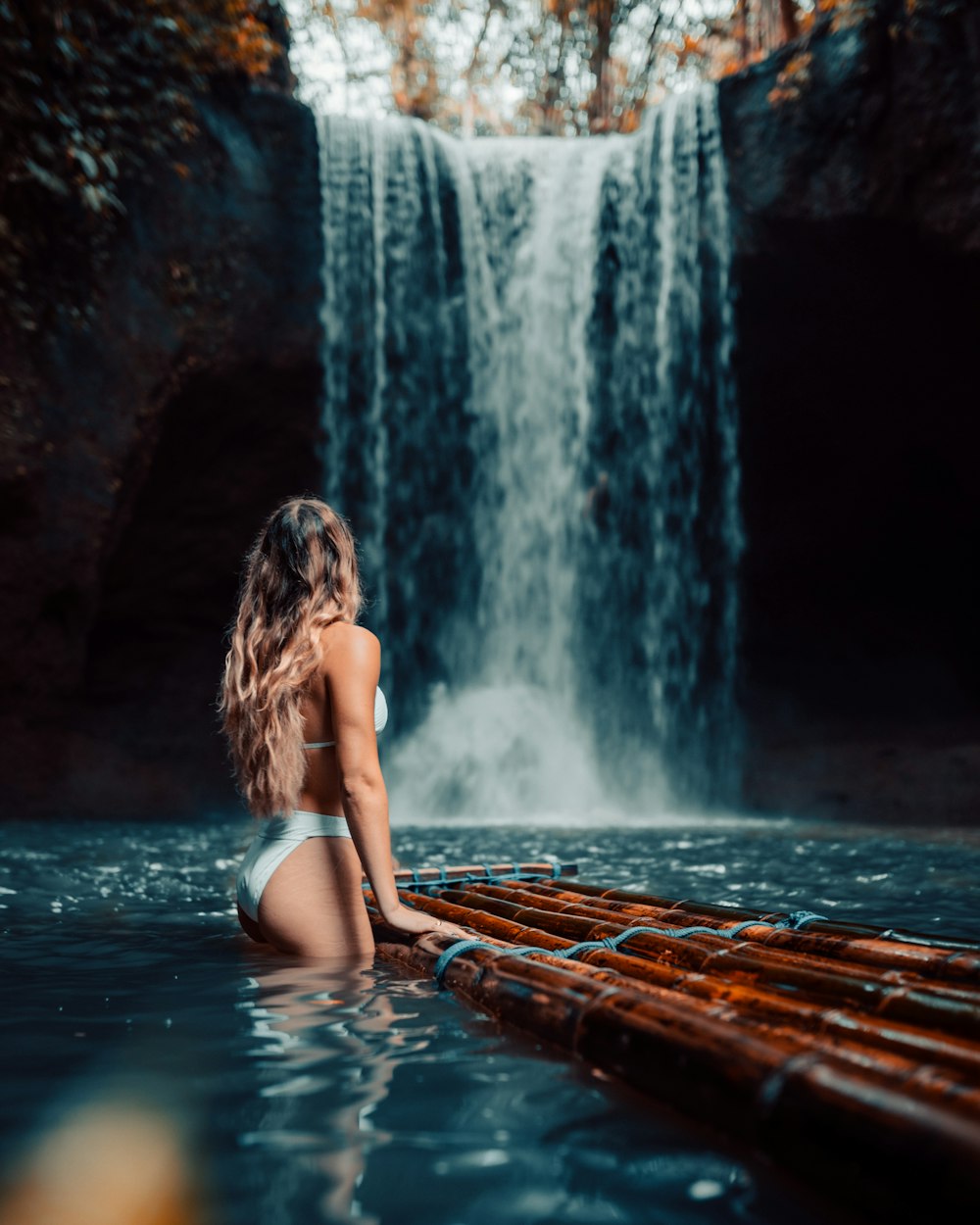 a person sitting next to a waterfall