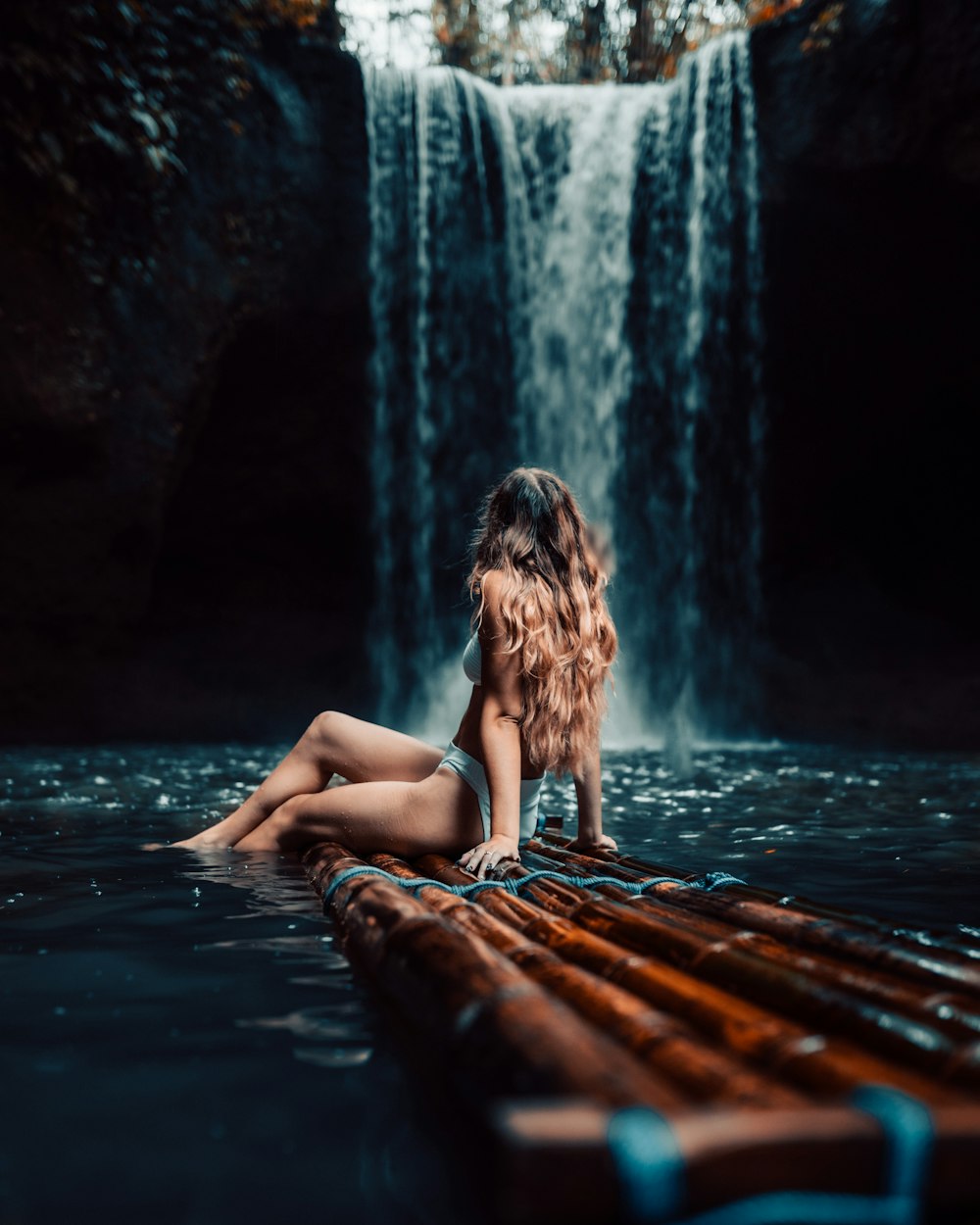 a person sitting next to a waterfall