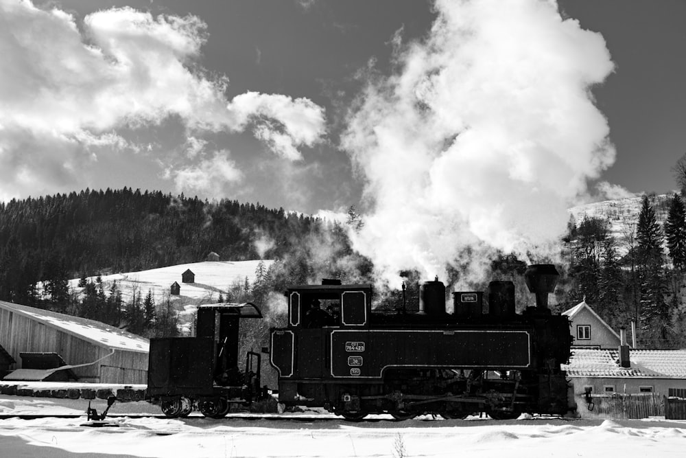 a steam train on a track with smoke coming out of it