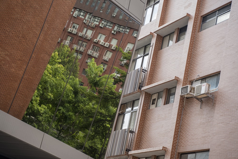 a tall brick building with windows and balconies