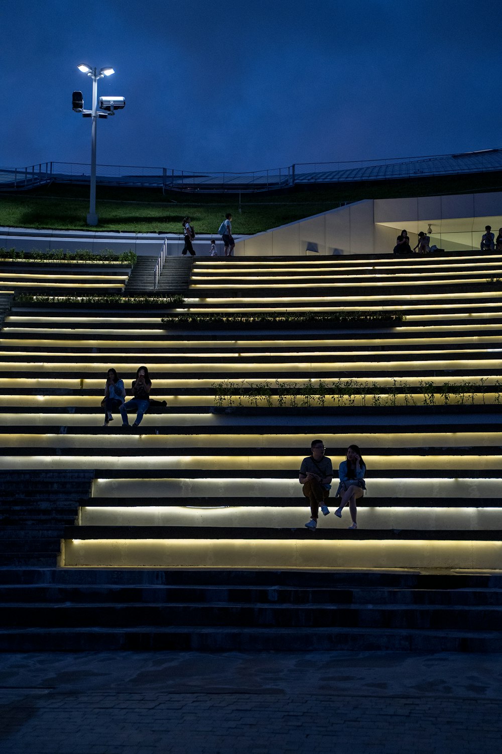 a group of people sitting on top of a set of steps