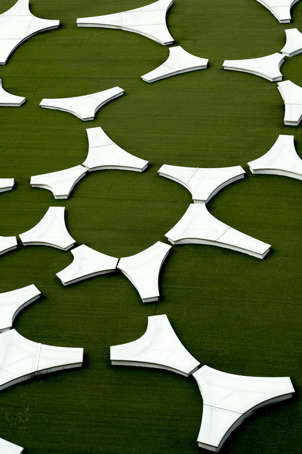 a group of mirrors sitting on top of a green field