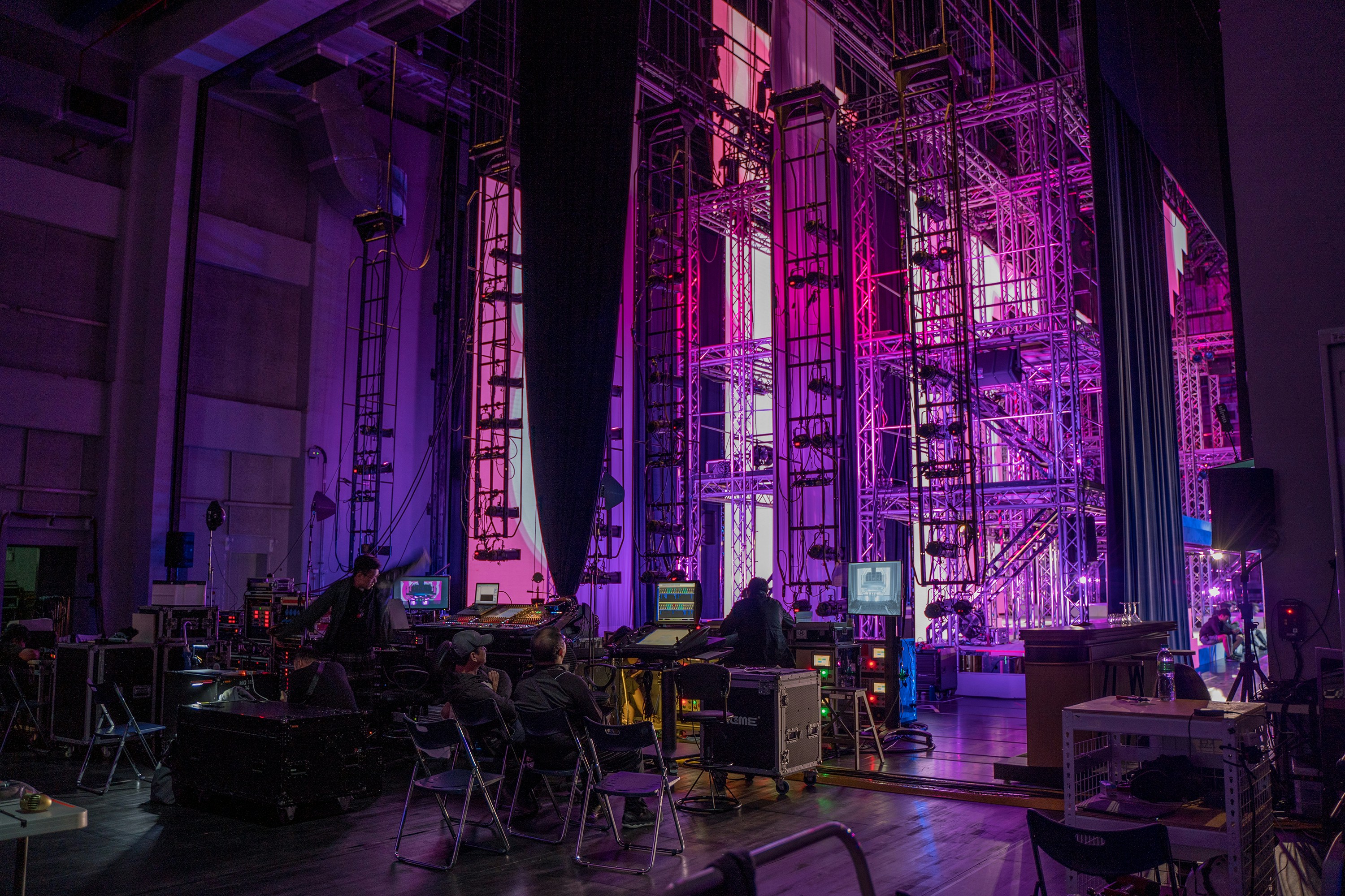 a stage set up for a concert with purple lighting