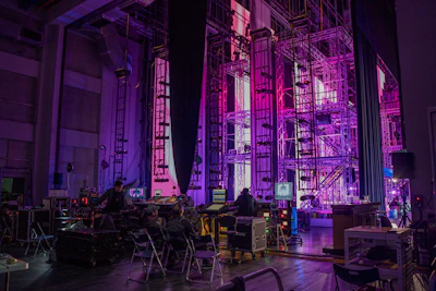 a stage set up for a concert with purple lighting
