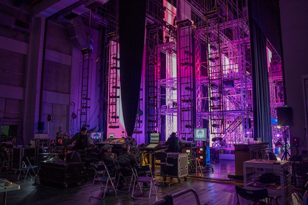 a stage set up for a concert with purple lighting