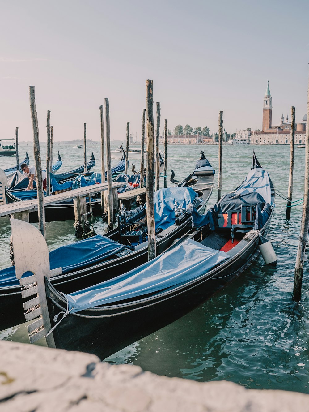 a row of gondolas sitting next to each other in a body of water