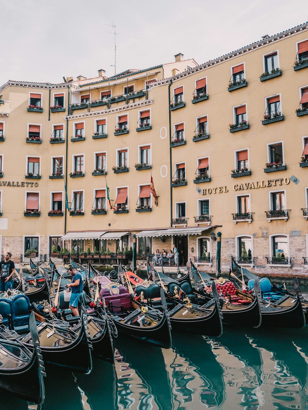 a row of gondolas in front of a hotel