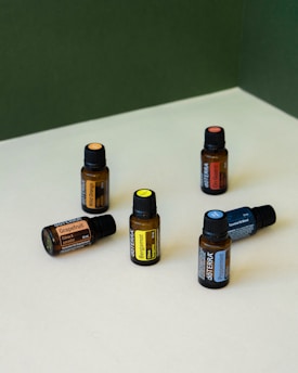 a group of bottles of essential oils sitting on a table
